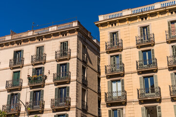 Fototapeta premium Building Facade With French Balconies and Wooden Shutters in Barcelona City in Spain