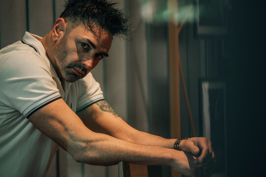 middle-aged man in his small business, deep in thought, hesitating or making a decision