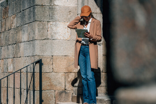 middle-aged woman on the street with a travel map