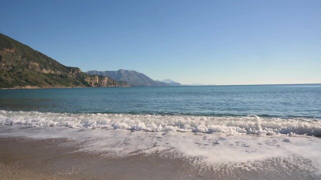 Waves Rolling onto Jaz Beach with Mountainous Adriatic Coastline in Montenegro