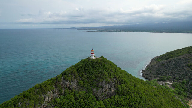 Lighthouse on Ilh&eacute;u das Cabras, S&atilde;o Tom&eacute; and Pr&iacute;ncipe, standing above a rugged volcanic islet with S&atilde;o Tom&eacute; Island visible in the background beneath dramatic clouds.Africa