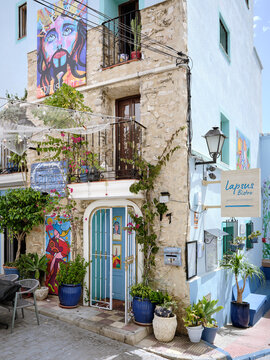 Lapsus Bistro facade with colorful street art, stonework and plants on June 7, 2026 in Calpe, Spain, showing a distinctive local restaurant in a Mediterranean urban setting