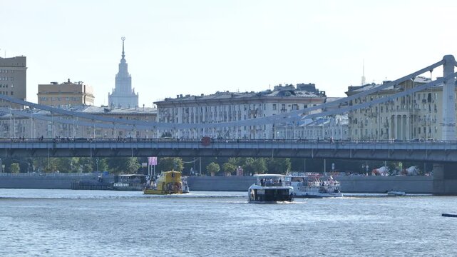 Moskva River with Krymsky Bridge, city skyline, and river boats on a clear day