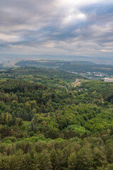 Fototapeta premium Layers of green mountains and hills in the haze during sunset. Panoramic View of Green hills and Meadow.