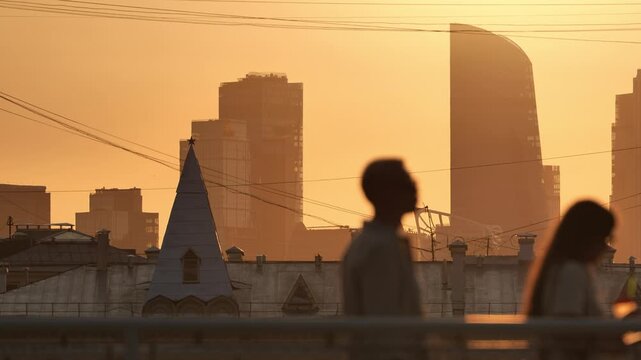 Moscow City skyline with pedestrians walking at sunset, urban city life