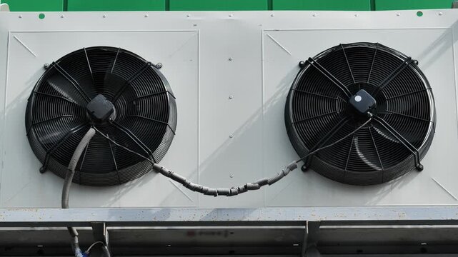 HVAC industrial cooling unit with two fans creating a smiling pareidolia face