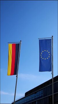 Waving flags from European Union and Germany a on blue sky background show european and germany represented by Germany flag and European Union flag as partners both flags as set