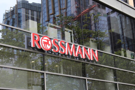 Warsaw, Poland, May 15, 2026. Exterior sign of Rossmann store on contemporary glass building facade reflecting metropolitan modern architecture. High quality photograph