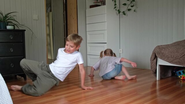 Happy active siblings exercising dancing together. Cute brother and sister jumping, doing fun sports routine. Fighting sedentary lifestyle in kids. Children physical health, energy wellness concept.