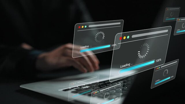 Abstract representation of computer loading screens on a laptop with a hand in focus in a dark environment illustrating the concept of technology and waiting Gluon.