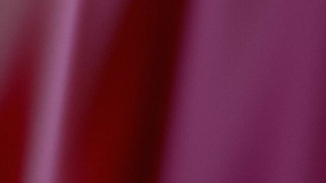 Grainy abstract background with purple, red and magenta light gradients