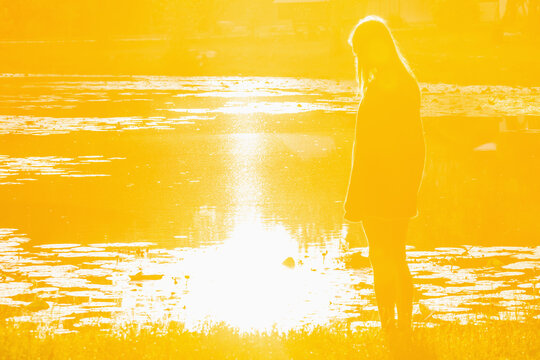 Growing up concept with a teenage girl facing the light of a new day. Copy space for text or design.