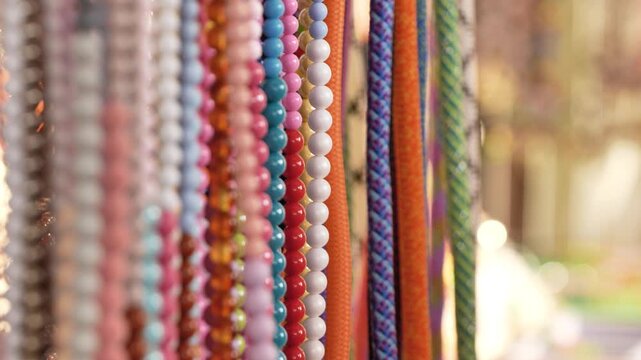 Colorful beads and ropes displaying artisan craft, handmade jewelry, and decorative string