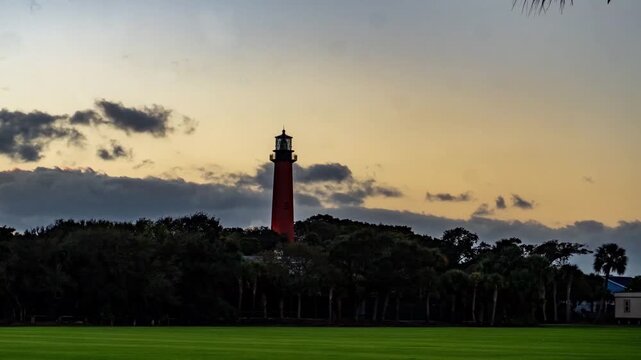 Travel and Landmarks: 4K Sunset Timelapse of the Historic Jupiter Inlet Lighthouse with Golden Morning Light and Passing Clouds, Florida