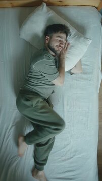 Time Lapse Overhead Man Tossing Turning in Bed Restless Sleep Positions Top View ,vertical video