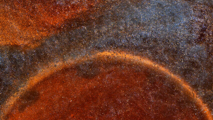 Mixing colors of alcohol ink creates abstract patterns in close-up view
