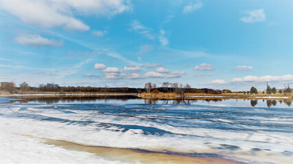 Obraz premium A stunning springtime landscape featuring a wide river with melting ice floes.