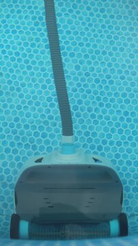 Automatic Robotic Pool Vacuum Cleaner Cleans an Above Ground Swimming Pool, Close Up