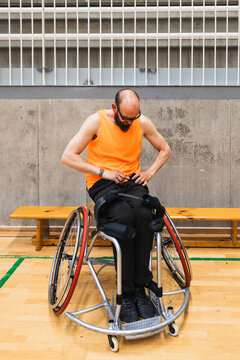 Athlete preparing for wheelchair basketball game indoors