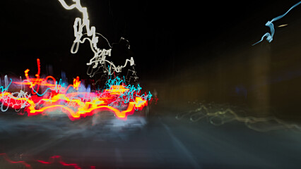 An intentional night-time motion-blur shot of a city street with cars. © claudio