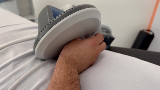 Person receiving pulsed electromagnetic field therapy on their wrist