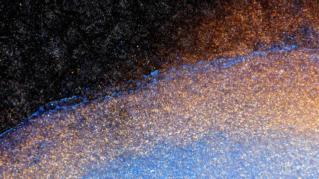 Mixing alcohol ink fragments under a macro lens showing vivid colors