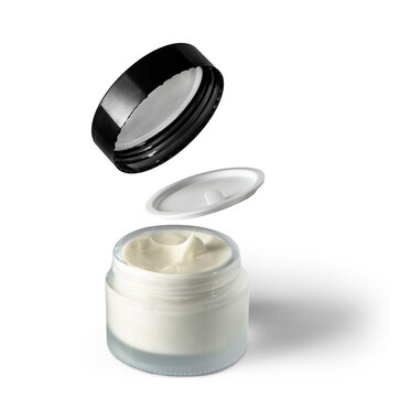 Open jar of white cosmetic cream with floating lid and inner seal over white background, with cream, cosmetic