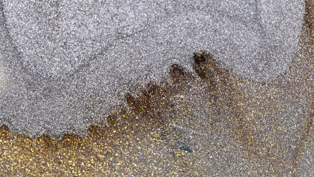 Mixing alcohol ink in macro detail showing colorful fragments