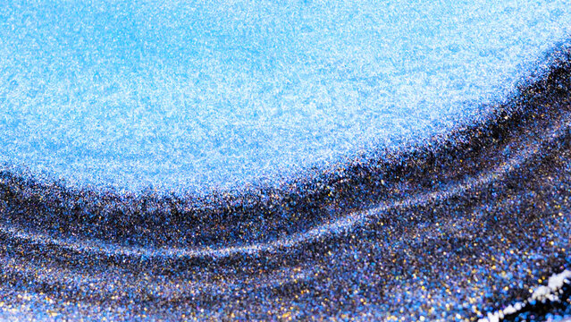Mixing alcohol ink in a macro view with swirling colors and patterns