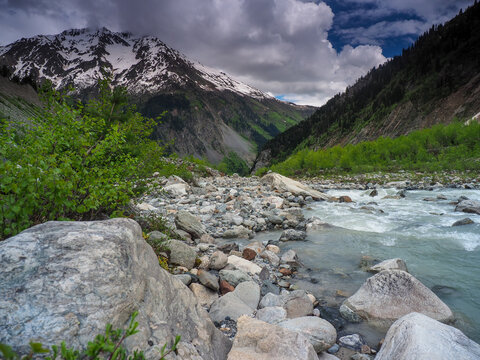 Glacial River Flowing in Caucasus Mountain Valley, copy space