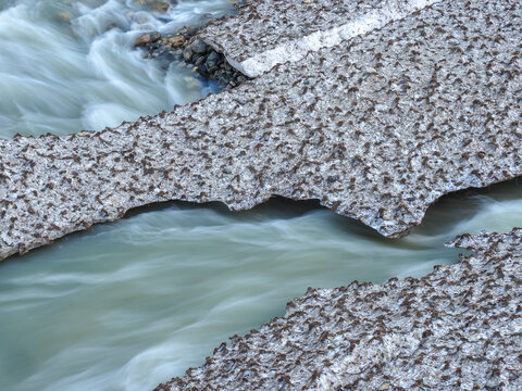 Glacial Stream Flowing Under Melting Snow Bridge, copy space