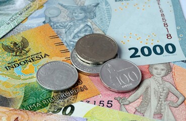 Indonesian rupiah money banknotes and coins on table. Indonesia cash bills of IDR currency © Viktor