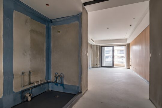 Hotel Room Ensuite Bathroom Under Construction with Waterproofing Membrane Open Plumbing and Unfinished Connections Details