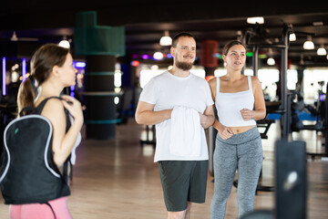 Fototapeta premium Training has ended in gym, visitors leave gym, leave workplace. Visitors of sports club come out after training