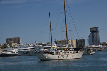 Sailing Yacht in Barcelona Harbor with Port Vell Skyline © Osvaldo