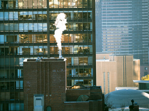 Rooftop Steam Plume Rising Between Manhattan Office Buildings