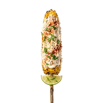 Delicious grilled Mexican street corn elote on a stick with lime.