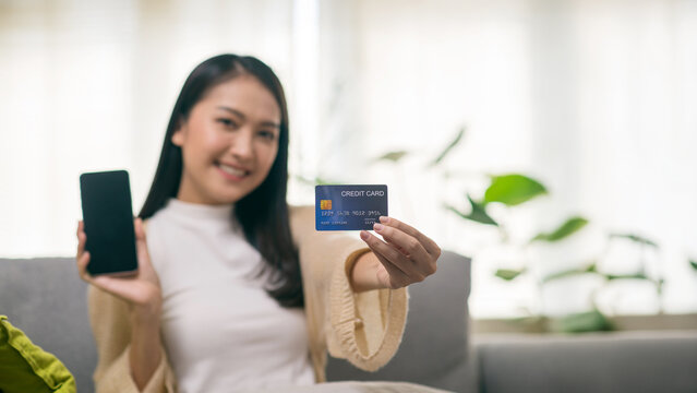 Young Asian Woman Using Smartphone and Credit Card for Online Shopping and Digital Payment
