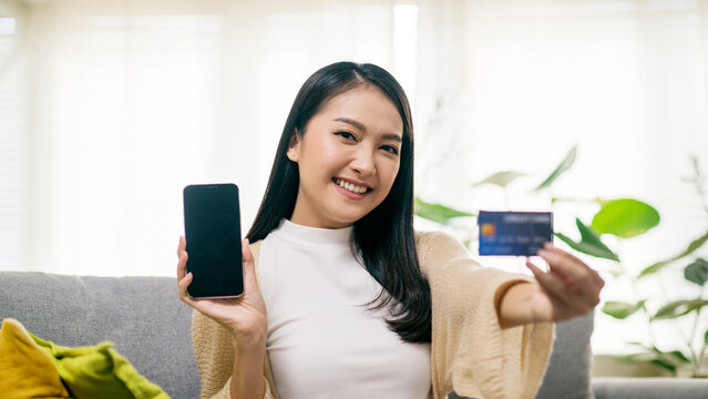 Young Asian Woman Using Smartphone and Credit Card for Online Shopping and Digital Payment