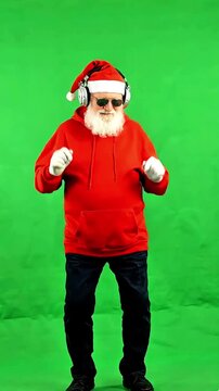 Cool Santa Claus in hoodie wearing sunglasses and headphones dancing isolated on green screen chromakey