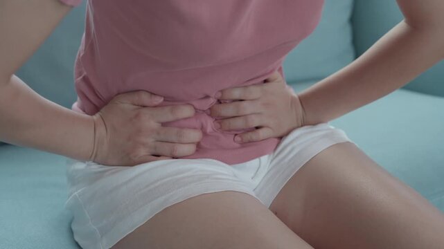 stomach ache. Asian women have abdominal pain, indigestion, gastritis, menstrual cramps, flatulence, diarrhea, distention, colon cancer, belly inflammation problem, suffer food poisoning, abdomen