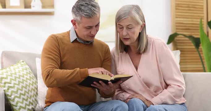 Pastor conducting Bible study with senior woman at home