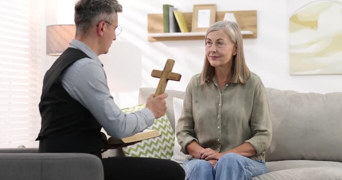 Pastor conducting Bible study with senior woman at home
