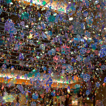 Vibrant holographic art installation with glittering colorful sparkles hanging from ceiling