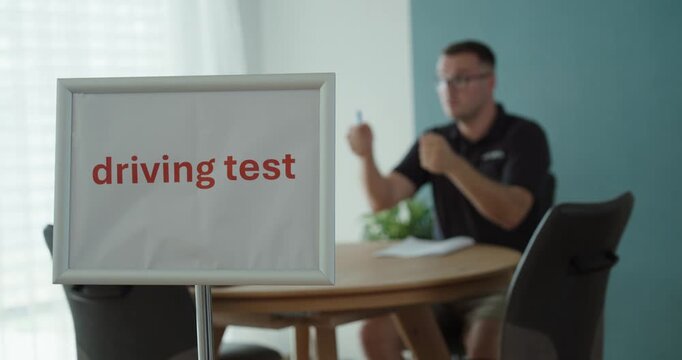 Driving test examiner reviewing documents and evaluating a candidate, representing driver license examination, assessment, road safety and driving qualification.