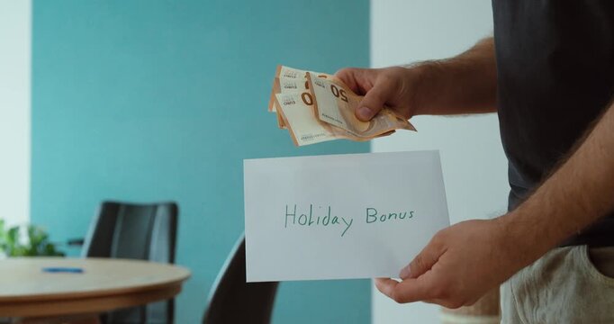 Person receiving euro banknotes as a holiday bonus payment, representing employee rewards, seasonal compensation, extra income and workplace benefits.
