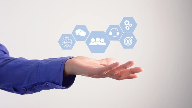 An outstretched hand holds an animation with inline work icons