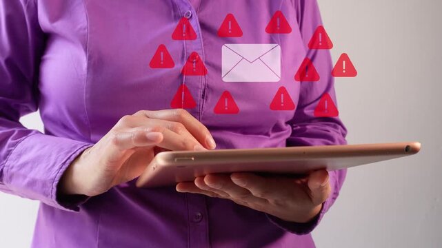 Person holds tablet with floating warning icons. Red alert symbols surround email icon. Suggests digital security risks or spam notifications. Ideal for cybersecurity, tech support