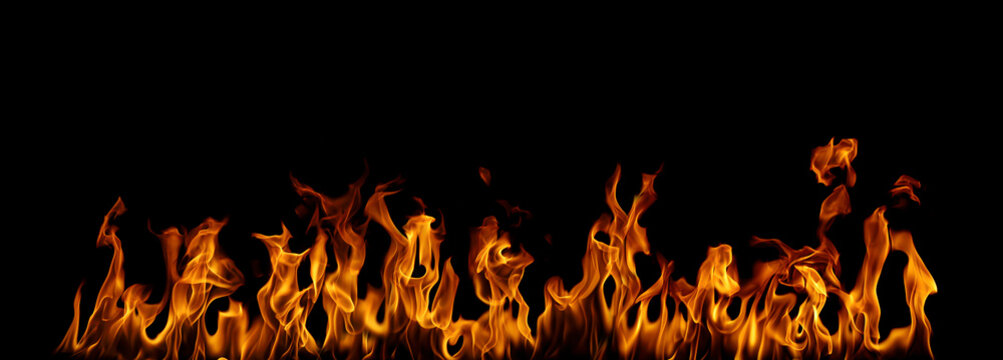 Realistic orange flames burning across a black background, creating a dramatic fire effect with bright yellow and red fire, heat, energy, danger, destruction, power, and intense glowing light effects.