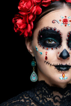 Halloween beauty close-up portrait of woman. Beautiful female face adorned with Santa Muerte makeup.